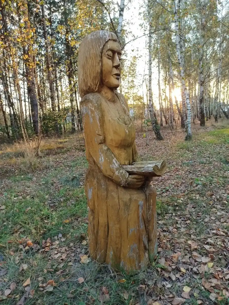 Drewniana rzeźba czytającej kobiety